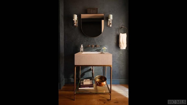 bathroom with wood-type flooring and sink