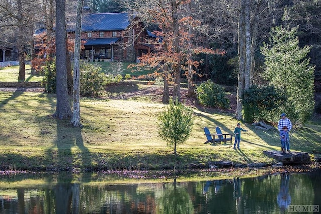 surrounding community featuring a yard and a water view