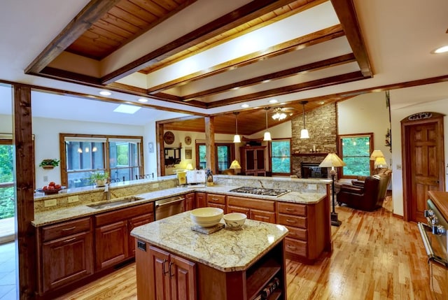 40 Piney Ridge Ct, Sapphire, NC 28774 - kitchen featuring stainless steel appliances, a stone fireplace, a kitchen island, open floor plan, and a ceiling fan
