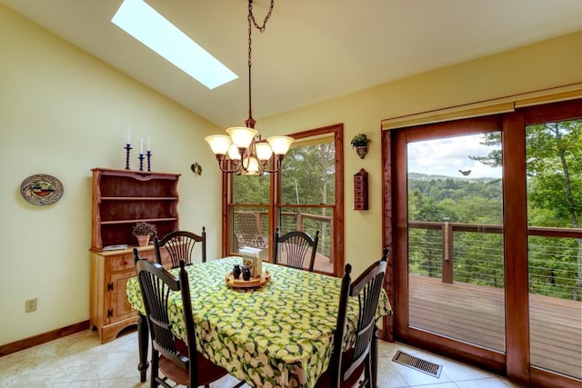40 Piney Ridge Ct, Sapphire, NC 28774 - dining area with a chandelier, a skylight, vaulted ceiling, and light tile patterned floors