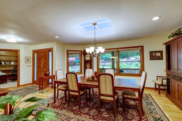 40 Piney Ridge Ct, Sapphire, NC 28774 - dining area with a chandelier, a skylight, light wood-type flooring, and recessed lighting