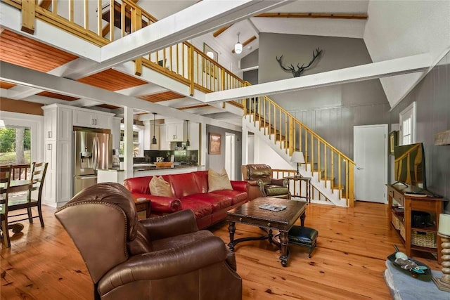 living area featuring stairway and light wood-type flooring