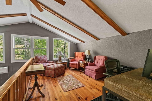 living area featuring light wood-style floors and a textured ceiling