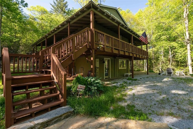 back of house featuring a deck and stairway