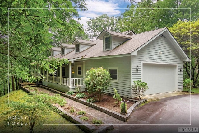 view of home's exterior with a porch and a garage