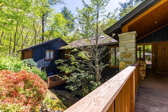 view of side of home with a wooden deck