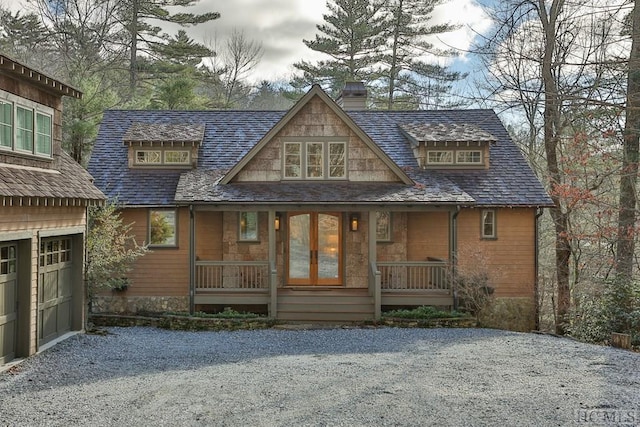 view of front of property featuring a porch and a garage