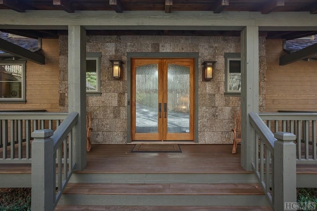 doorway to property with french doors and a porch