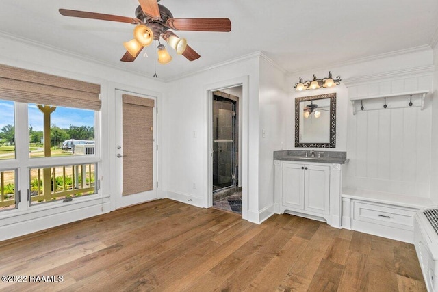 interior space with crown molding, ceiling fan, and hardwood / wood-style flooring