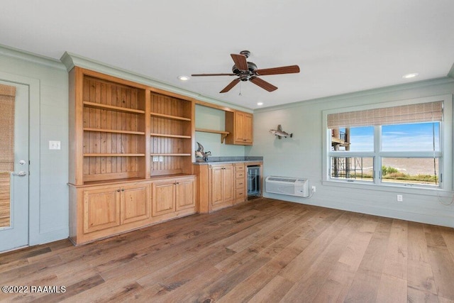 unfurnished living room with ceiling fan, ornamental molding, and hardwood / wood-style flooring