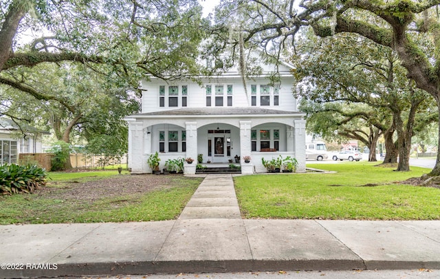 view of front of home with covered porch and a front lawn