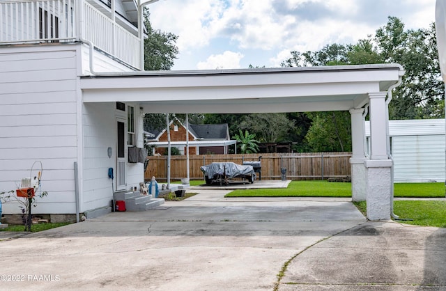 view of vehicle parking with a lawn