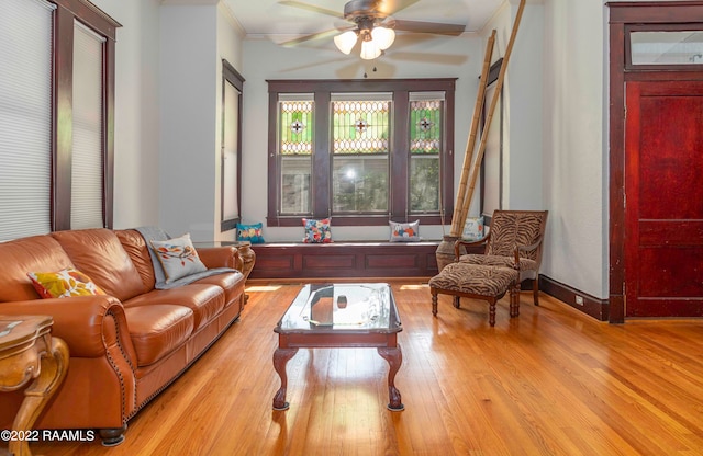 living room featuring light hardwood / wood-style flooring and ceiling fan