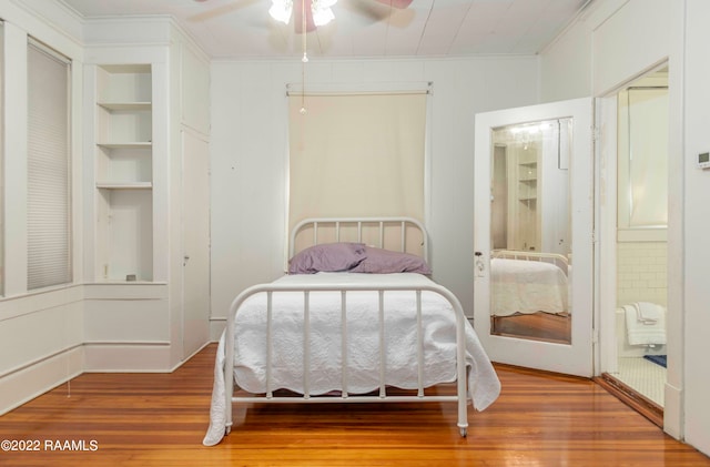 bedroom with ceiling fan, light wood-type flooring, and crown molding