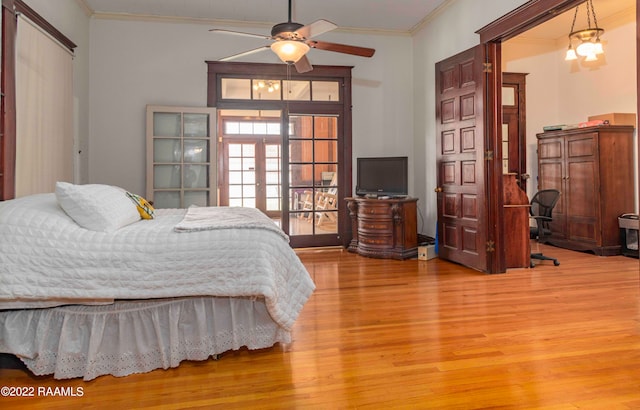 bedroom featuring french doors, light hardwood / wood-style floors, and ornamental molding