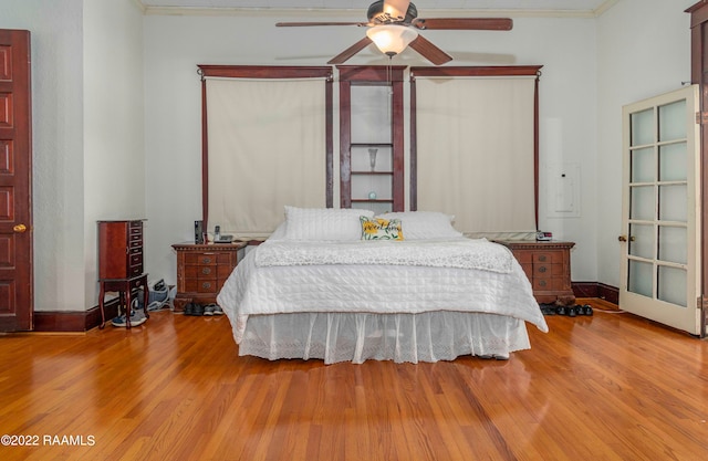 bedroom with ornamental molding, light hardwood / wood-style floors, and ceiling fan