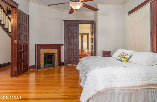 bedroom featuring crown molding, ceiling fan, and light wood-type flooring