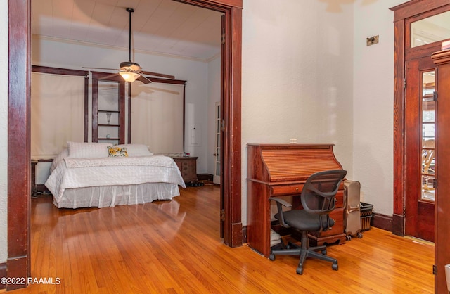 bedroom featuring ornamental molding, ceiling fan, and light wood-type flooring