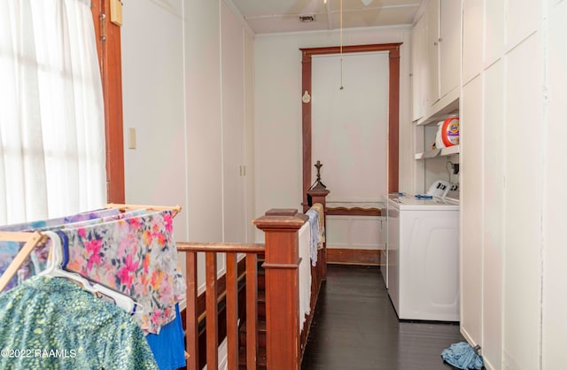 bedroom featuring crown molding, washing machine and dryer, and dark wood-type flooring