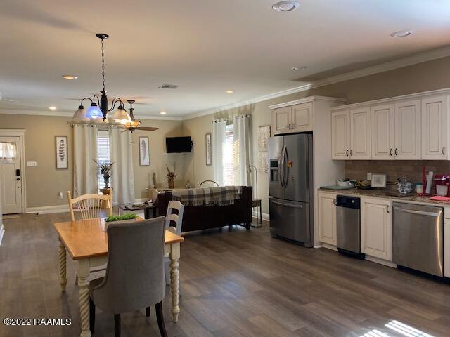 dining room with a chandelier, dark hardwood / wood-style floors, and ornamental molding