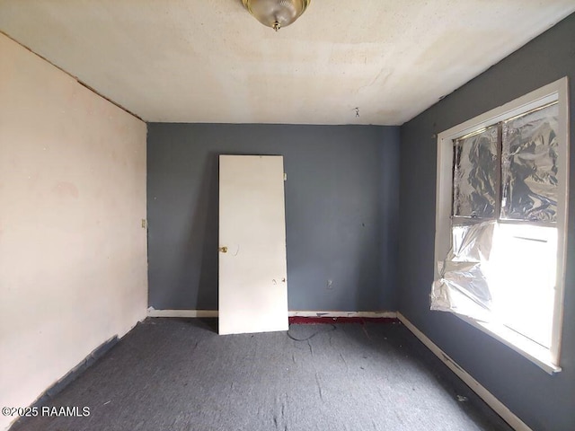 805 Edna St, New Iberia, LA 70560 - spare room featuring dark carpet and baseboards