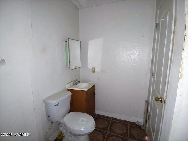 805 Edna St, New Iberia, LA 70560 - half bathroom featuring toilet, tile patterned flooring, baseboards, and vanity