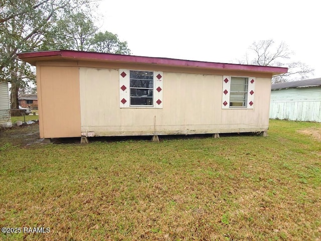 805 Edna St, New Iberia, LA 70560 - view of side of property with an outbuilding, a yard, and fence