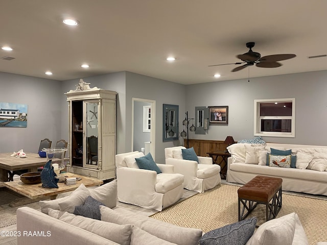 carpeted living room featuring ceiling fan