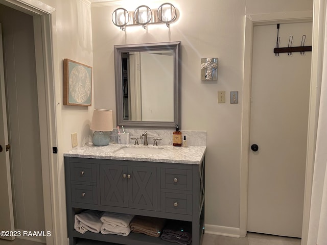 bathroom with crown molding and vanity