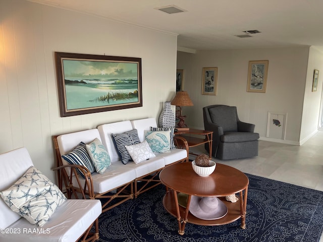 living room with light tile floors and ornamental molding