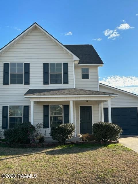 front of property with a front yard and a porch