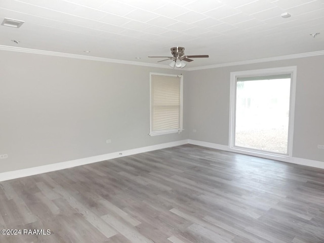 spare room featuring ceiling fan, crown molding, and hardwood / wood-style flooring