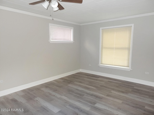 empty room with crown molding, dark hardwood / wood-style floors, and ceiling fan