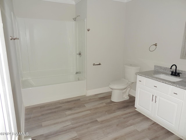 full bathroom featuring hardwood / wood-style flooring, toilet, vanity, and shower / bath combination