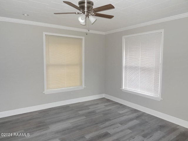 spare room with crown molding, ceiling fan, and dark wood-type flooring