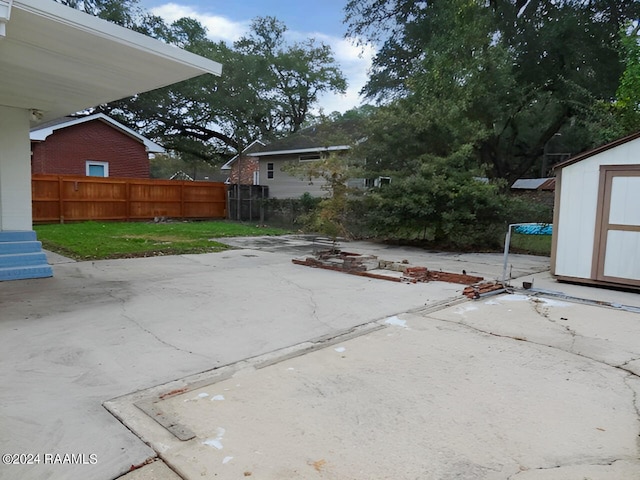 view of terrace with a shed