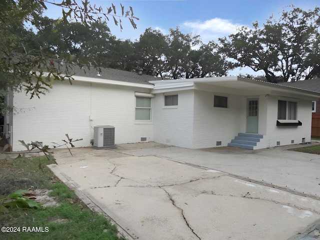 back of property with a patio area and central air condition unit