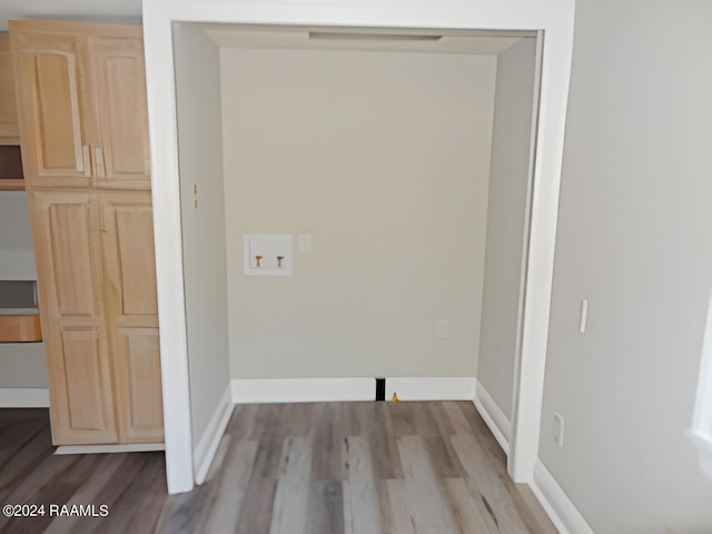 laundry room with hookup for a washing machine and light hardwood / wood-style flooring