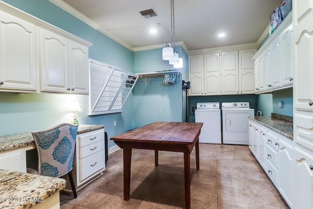 interior space featuring light tile floors, white cabinets, pendant lighting, and washing machine and dryer