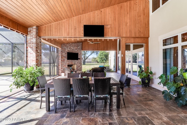 sunroom featuring lofted ceiling and wooden ceiling