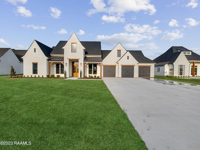 view of front of home with a front yard and a garage