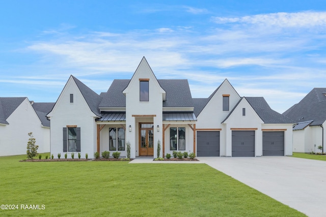 modern inspired farmhouse with a garage and a front lawn