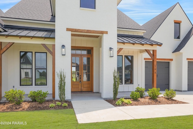 entrance to property with a garage and french doors