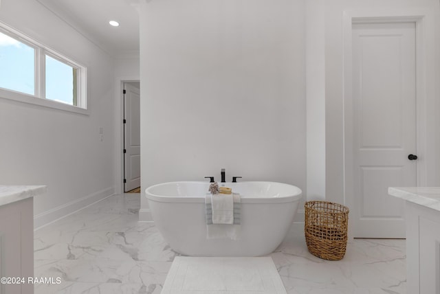 bathroom featuring vanity, crown molding, and a bath