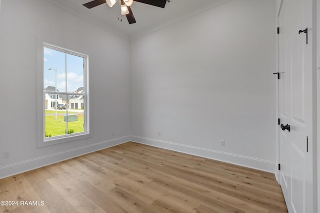 spare room with ceiling fan, light wood-type flooring, and crown molding