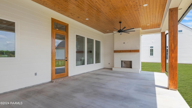 view of patio / terrace featuring an outdoor brick fireplace and ceiling fan