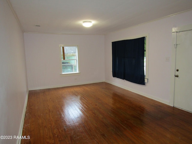 spare room featuring crown molding and hardwood / wood-style flooring