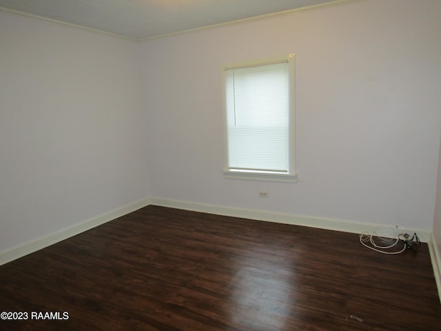 spare room featuring ornamental molding and hardwood / wood-style floors