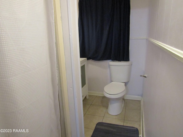 bathroom featuring toilet and tile flooring