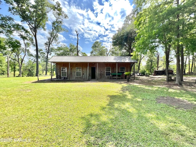 back of property featuring a yard